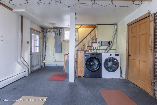 basement featuring a baseboard radiator, washing machine and dryer, stairway, and electric panel