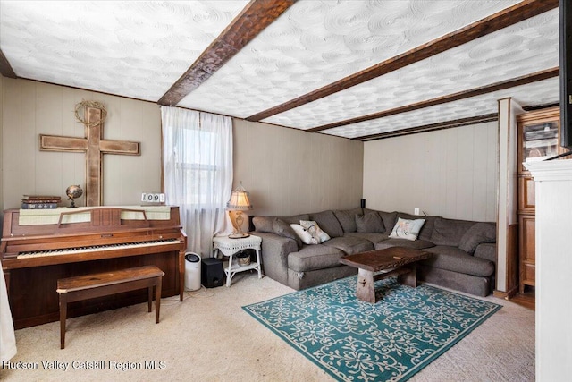 carpeted living room featuring a textured ceiling and beam ceiling