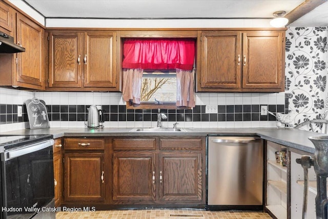 kitchen with electric range oven, a sink, under cabinet range hood, brown cabinetry, and stainless steel dishwasher