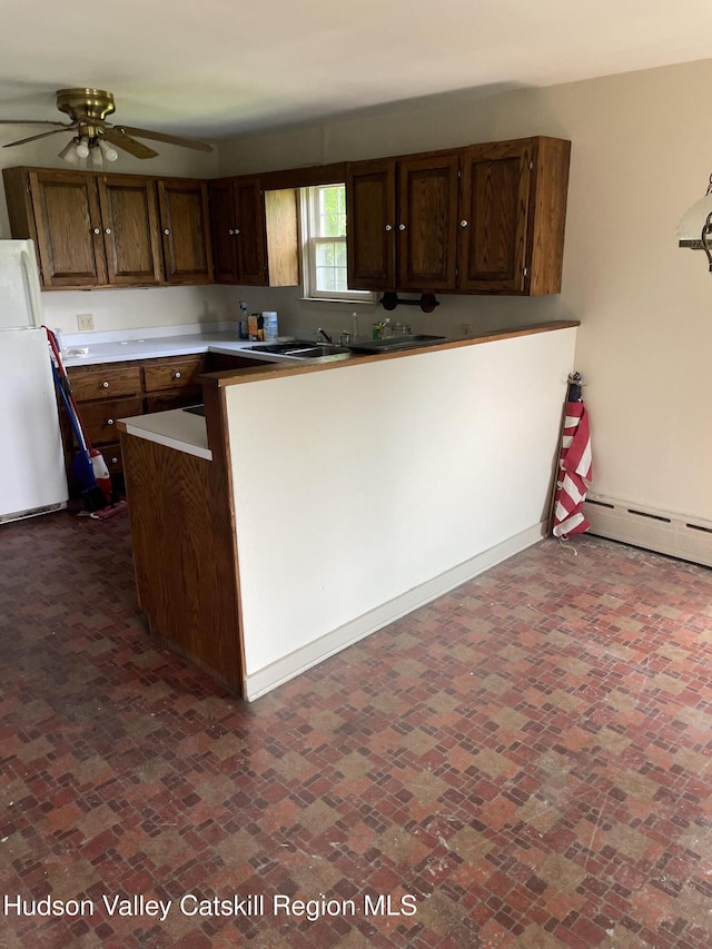 12 Fabiano Blvd, Hudson, NY 12534 - kitchen featuring ceiling fan, brick patterned floors, freestanding refrigerator, and baseboard heating