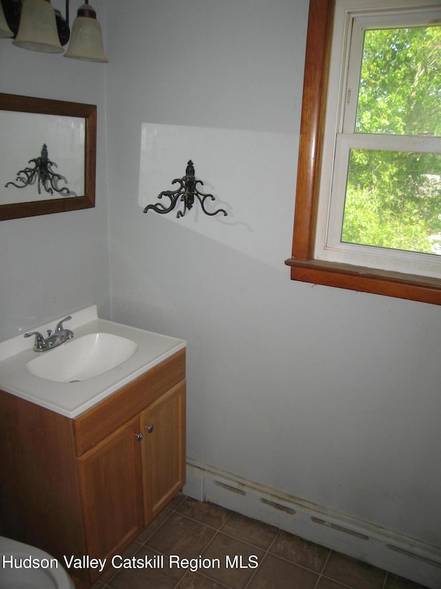12 Fabiano Blvd, Hudson, NY 12534 - half bath with vanity, a baseboard heating unit, healthy amount of natural light, and tile patterned floors