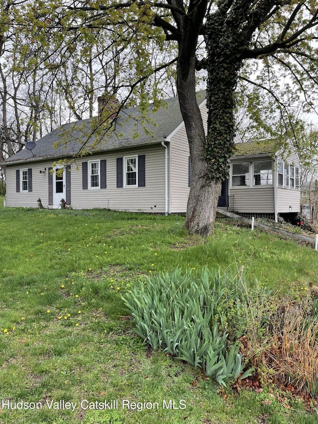 12 Fabiano Blvd, Hudson, NY 12534 - view of front of house with a front lawn, a sunroom, and a chimney