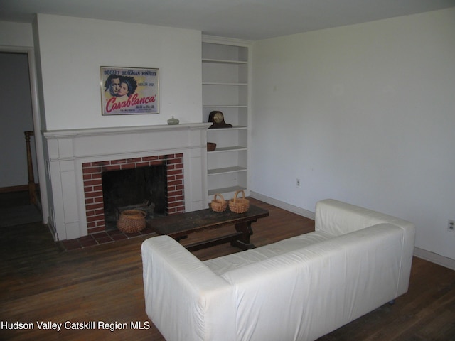 12 Fabiano Blvd, Hudson, NY 12534 - living room featuring wood finished floors, built in shelves, and a fireplace