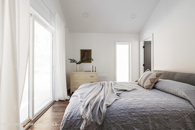 bedroom featuring vaulted ceiling, access to outside, and dark wood-type flooring