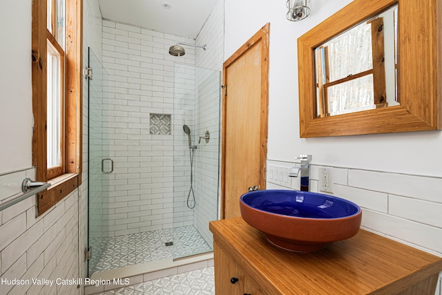 bathroom featuring vanity and an enclosed shower