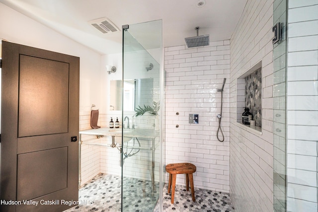 bathroom featuring a shower with shower door