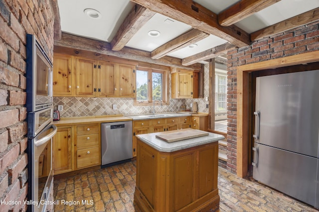 455 Post Hill Rd, Craryville, NY 12534 - kitchen featuring stainless steel appliances, light countertops, brick floors, decorative backsplash, and beam ceiling