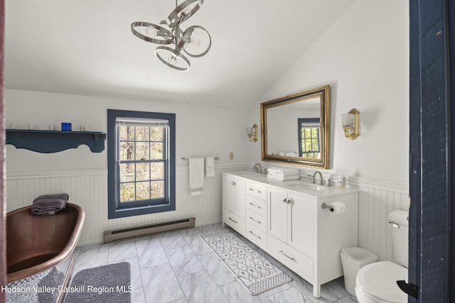 455 Post Hill Rd, Craryville, NY 12534 - full bath featuring a baseboard heating unit, a wainscoted wall, marble finish flooring, double vanity, and vaulted ceiling