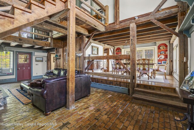 455 Post Hill Rd, Craryville, NY 12534 - living area with a baseboard heating unit, an AC wall unit, and brick flooring