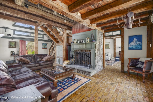 455 Post Hill Rd, Craryville, NY 12534 - living area featuring stairs, brick flooring, a fireplace with raised hearth, a wood ceiling with exposed beams, and a chandelier