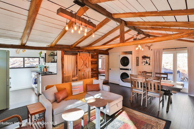 living room with stacked washer / drying machine, a barn door, lofted ceiling with beams, and dark wood-type flooring