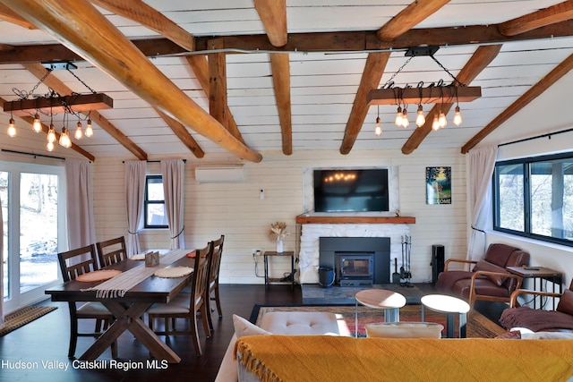 dining room featuring dark wood-type flooring, an AC wall unit, lofted ceiling with beams, and a notable chandelier