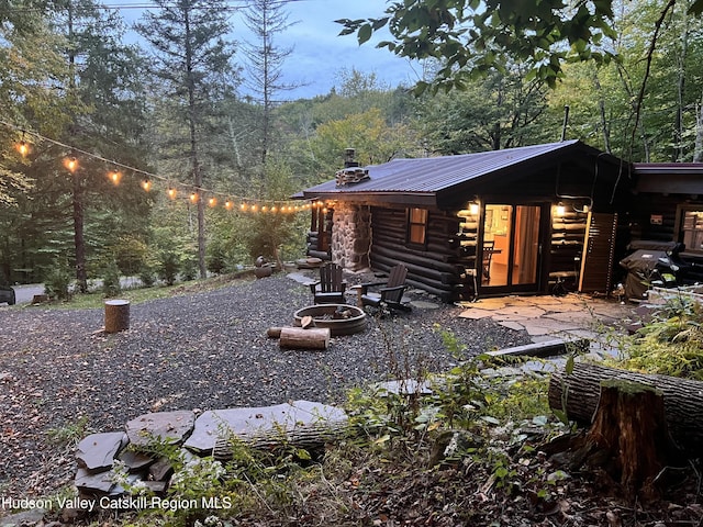 view of property exterior featuring a fire pit