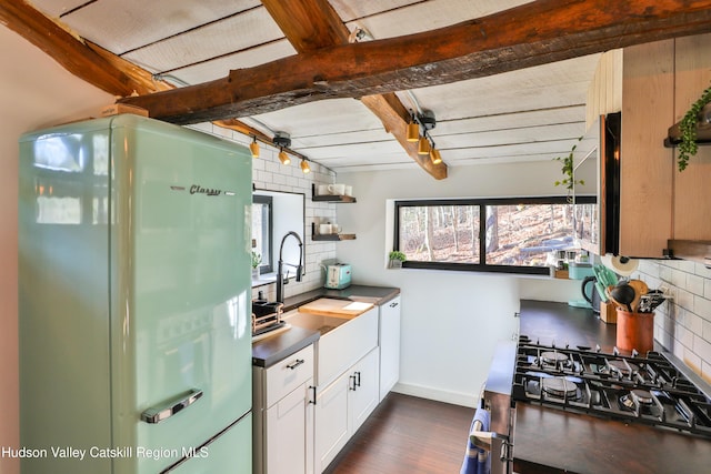 kitchen featuring sink, backsplash, white cabinets, and white fridge