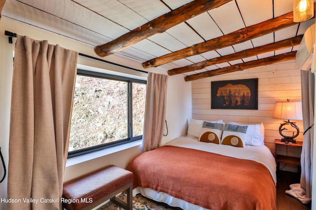 bedroom featuring wooden ceiling, wooden walls, and vaulted ceiling with beams