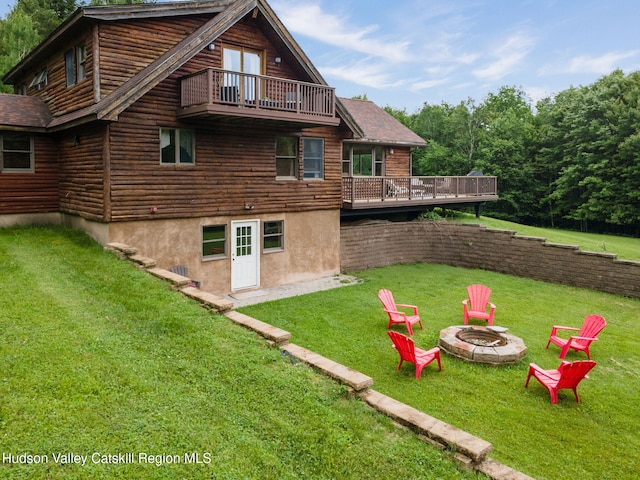 552 Bearkill Rd, Gilboa, NY 12076 - rear view of house featuring a fire pit, a balcony, a wooden deck, and a yard