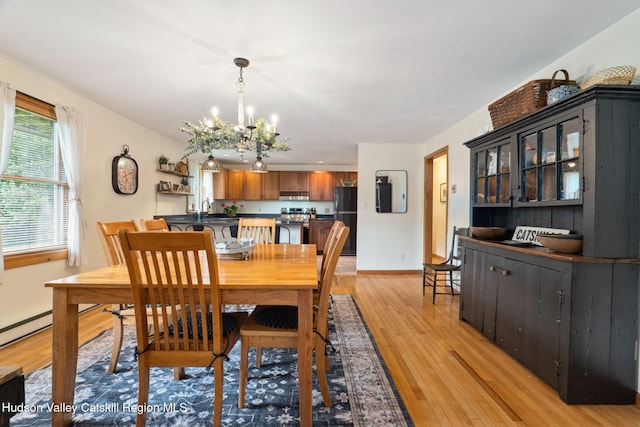552 Bearkill Rd, Gilboa, NY 12076 - dining room with a chandelier and light wood-style floors