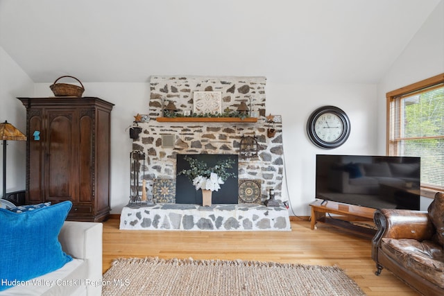 552 Bearkill Rd, Gilboa, NY 12076 - living room with light wood-style flooring, vaulted ceiling, and a stone fireplace