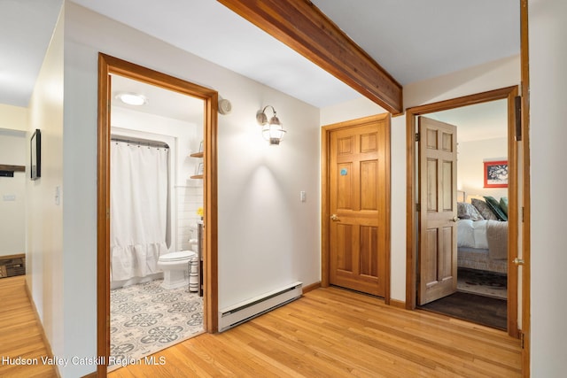 552 Bearkill Rd, Gilboa, NY 12076 - corridor featuring a baseboard radiator, light wood-style flooring, and beamed ceiling
