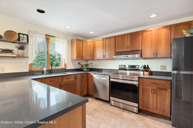 552 Bearkill Rd, Gilboa, NY 12076 - kitchen featuring stainless steel appliances, under cabinet range hood, dark countertops, brown cabinets, and recessed lighting