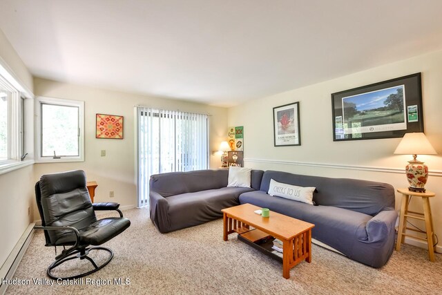 carpeted living room featuring a baseboard radiator and baseboards
