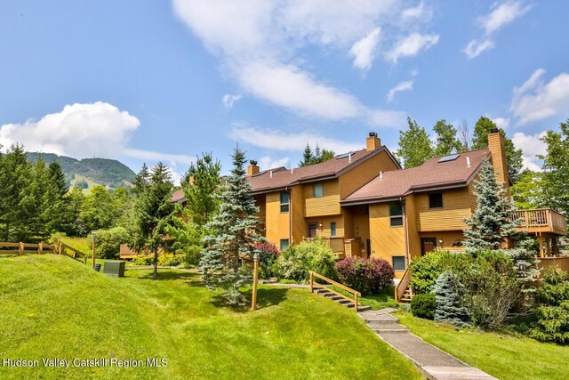 view of property with stairway, a mountain view, and fence