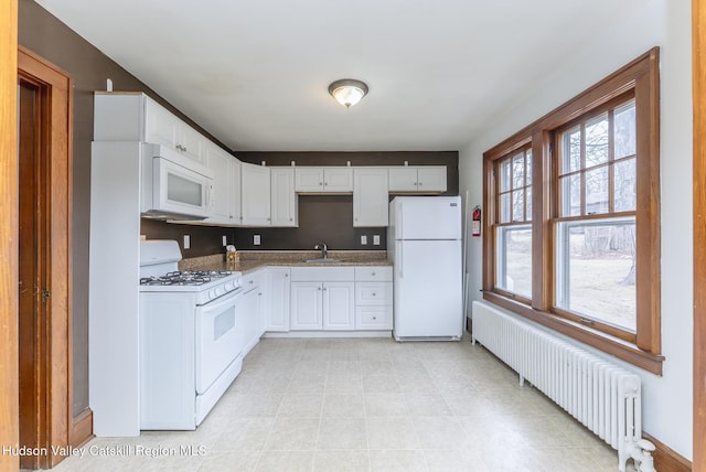 kitchen with white cabinetry, white appliances, radiator, and a sink