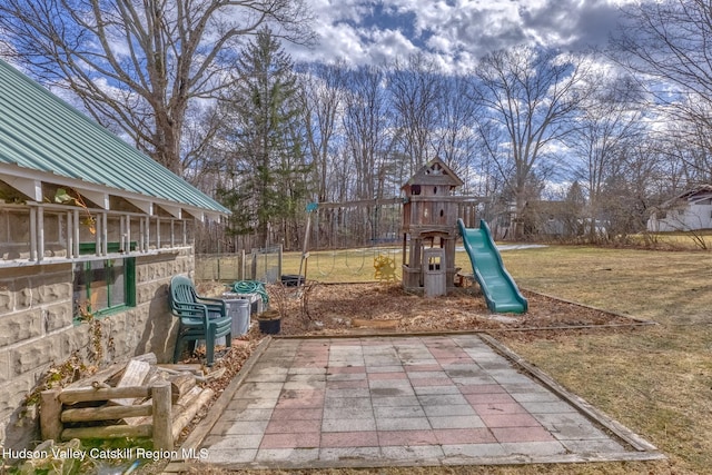 community playground featuring a lawn and fence