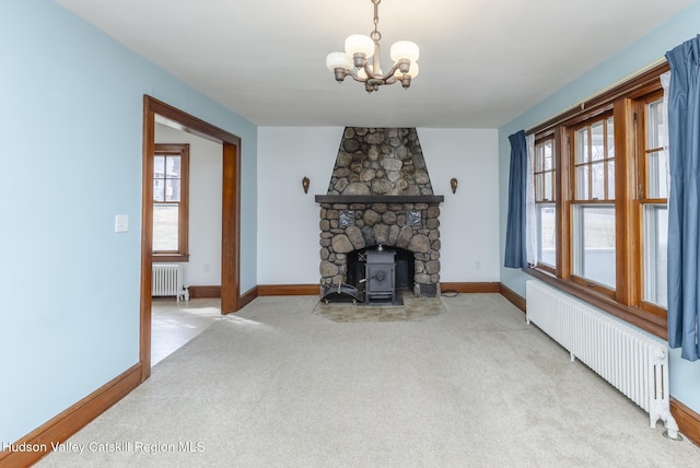 living area with a wealth of natural light, radiator heating unit, and carpet