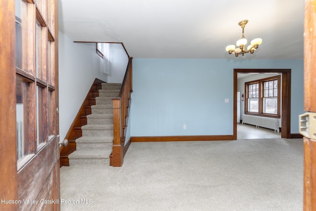 stairway with carpet flooring, radiator, baseboards, and a chandelier