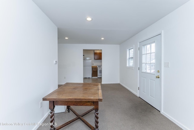 carpeted entryway with recessed lighting and baseboards