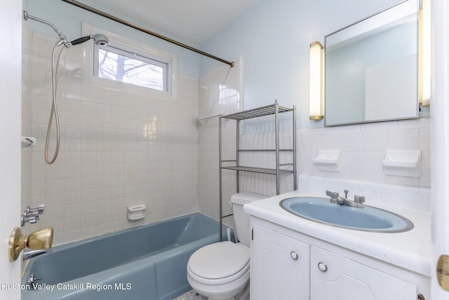 full bath featuring vanity, decorative backsplash, shower / tub combination, toilet, and tile walls