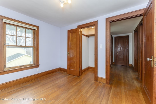 unfurnished bedroom featuring baseboards and light wood finished floors