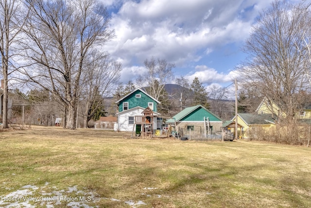 rear view of property with a lawn