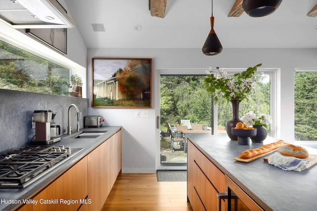 64 Dug Rd, Accord, NY 12404 - kitchen with stainless steel gas stovetop, light wood-type flooring, ventilation hood, modern cabinets, and hanging light fixtures