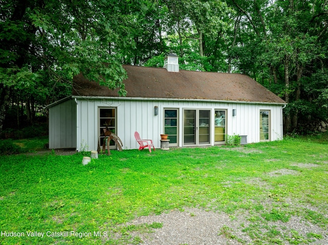 64 Dug Rd, Accord, NY 12404 - back of house featuring board and batten siding, a lawn, and a chimney