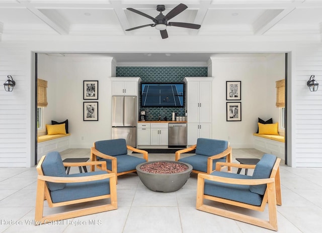 living room with light tile patterned floors, beamed ceiling, and coffered ceiling