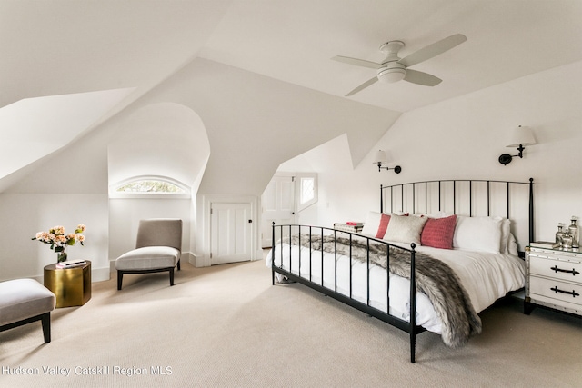 carpeted bedroom with ceiling fan and lofted ceiling