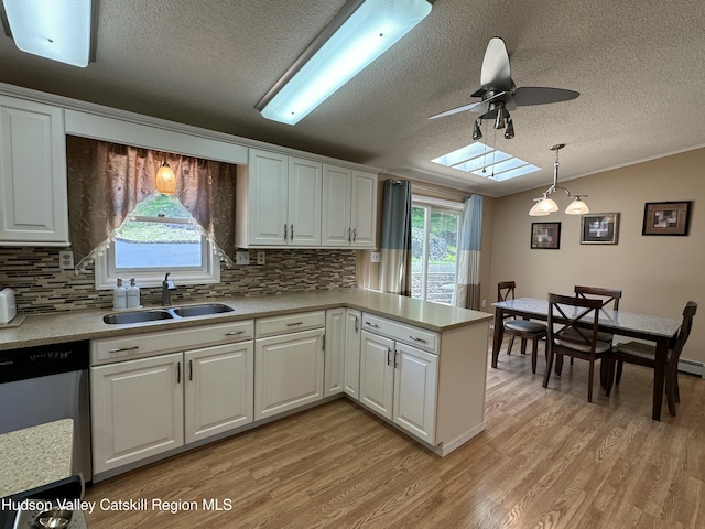 50 County Rte 26, Coxsackie, NY 12192 - kitchen featuring a sink, dishwasher, a textured ceiling, a ceiling fan, and light wood-style floors