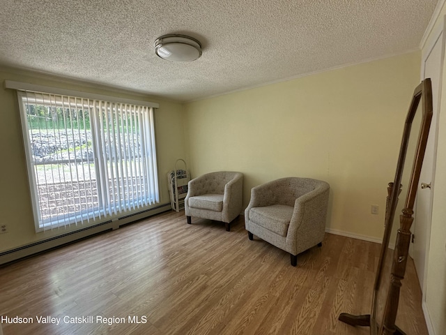 50 County Rte 26, Coxsackie, NY 12192 - living area with a textured ceiling, wood finished floors, and baseboard heating