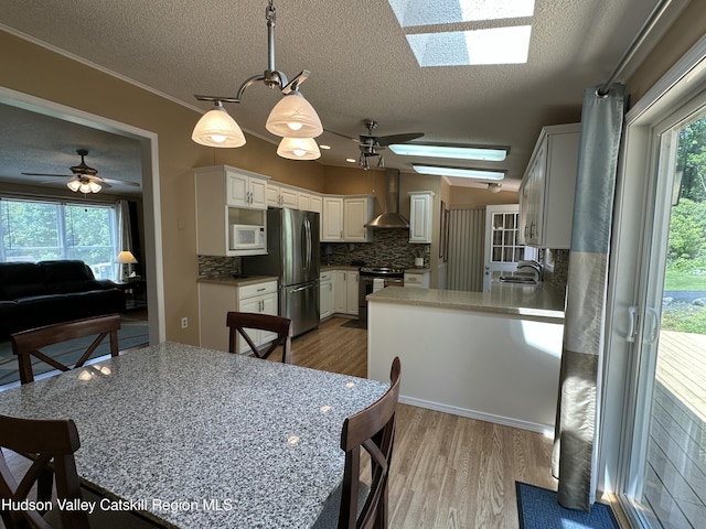 50 County Rte 26, Coxsackie, NY 12192 - dining room with a skylight, wood finished floors, a textured ceiling, and ceiling fan