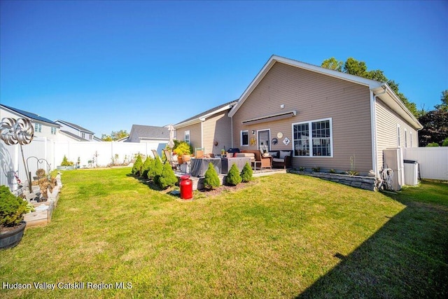 rear view of property with a lawn and an outdoor living space