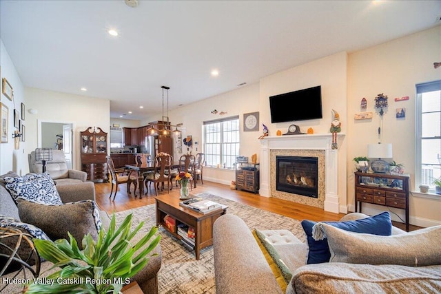 living room with a wealth of natural light and light hardwood / wood-style floors