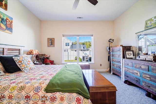 carpeted bedroom featuring ceiling fan and multiple windows