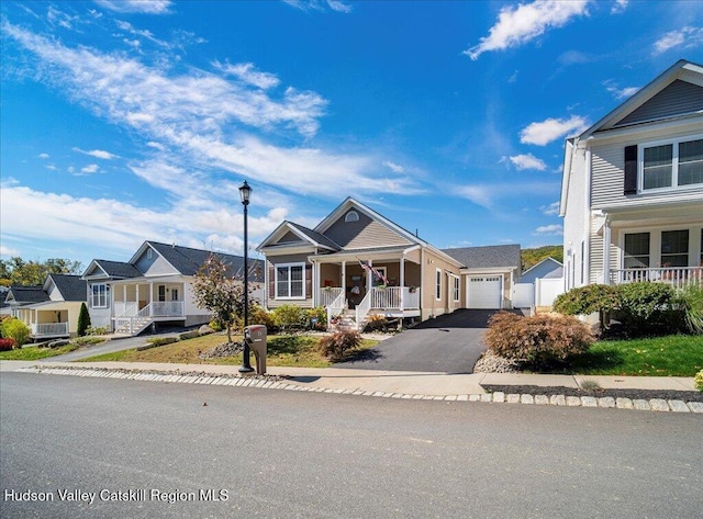 view of front of home featuring covered porch and a garage