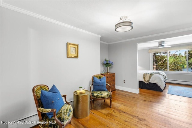162 Methodist Farm Rd, Averill Park, NY 12018 - sitting room with a baseboard heating unit, baseboard heating, crown molding, and wood-type flooring