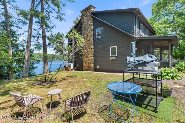 162 Methodist Farm Rd, Averill Park, NY 12018 - back of property featuring a sunroom, a yard, a chimney, and a water view