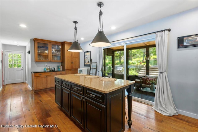 162 Methodist Farm Rd, Averill Park, NY 12018 - kitchen with wood-type flooring, a kitchen island, hanging light fixtures, glass insert cabinets, and recessed lighting