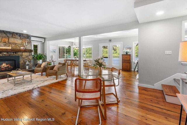162 Methodist Farm Rd, Averill Park, NY 12018 - dining space with an AC wall unit, healthy amount of natural light, and hardwood / wood-style flooring