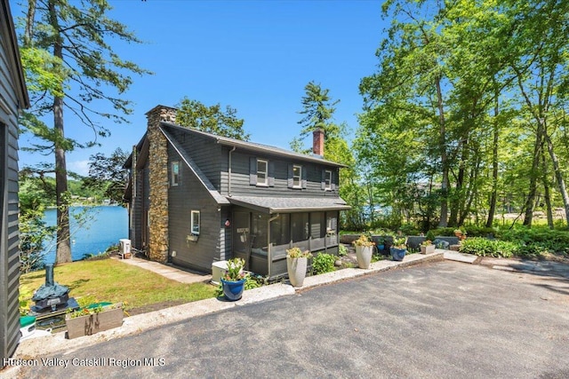 162 Methodist Farm Rd, Averill Park, NY 12018 - view of front facade with a chimney, a sunroom, and a patio